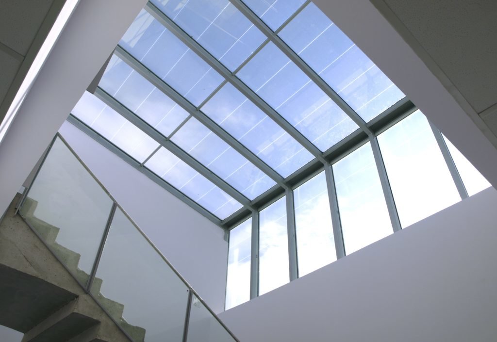 Photovoltaic glass integrated in skylights allows building owners to use both natural lighting and solar power. 